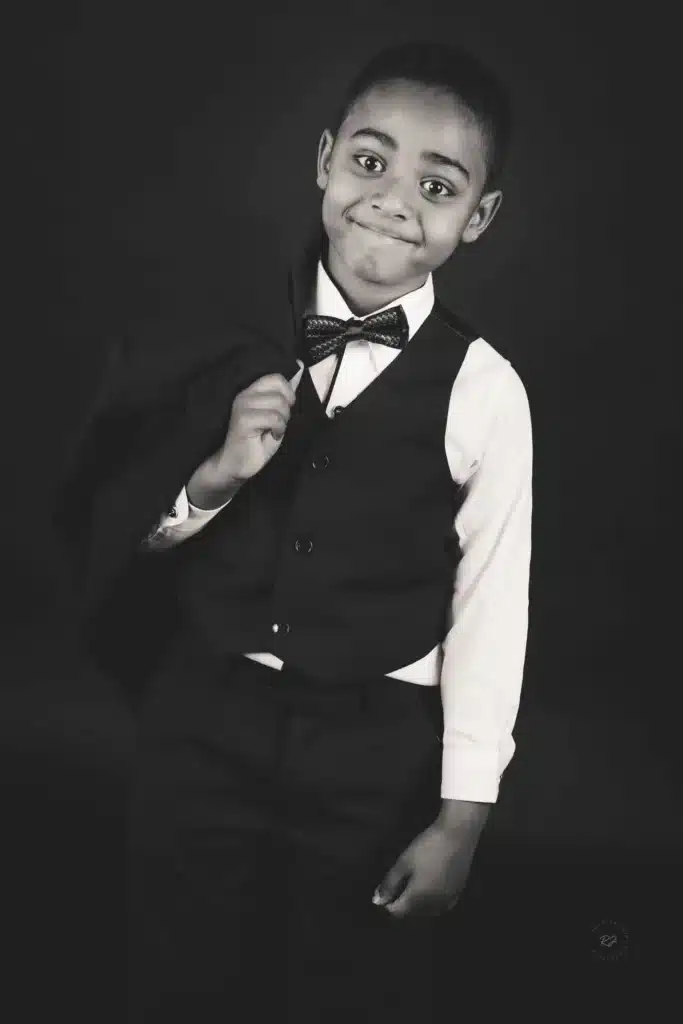 Two children playing with bubbles during an outdoor photo shoot in Wellington